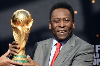 Pele pictured with the World Cup trophy ahead of Brazil 2014.