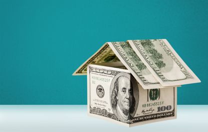 rendering of a house made of dollar bills on a turquoise background