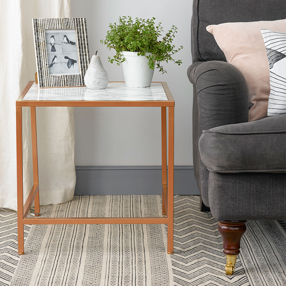 marble top table with plant pot and sofa