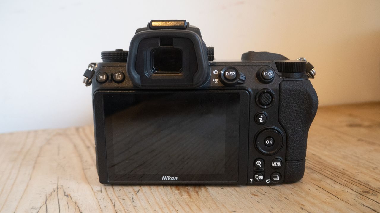 A photo of the Nikon Z6 II with a lens on a wooden table.