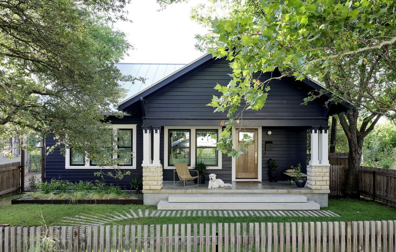 A backyard with lush grass and fencing