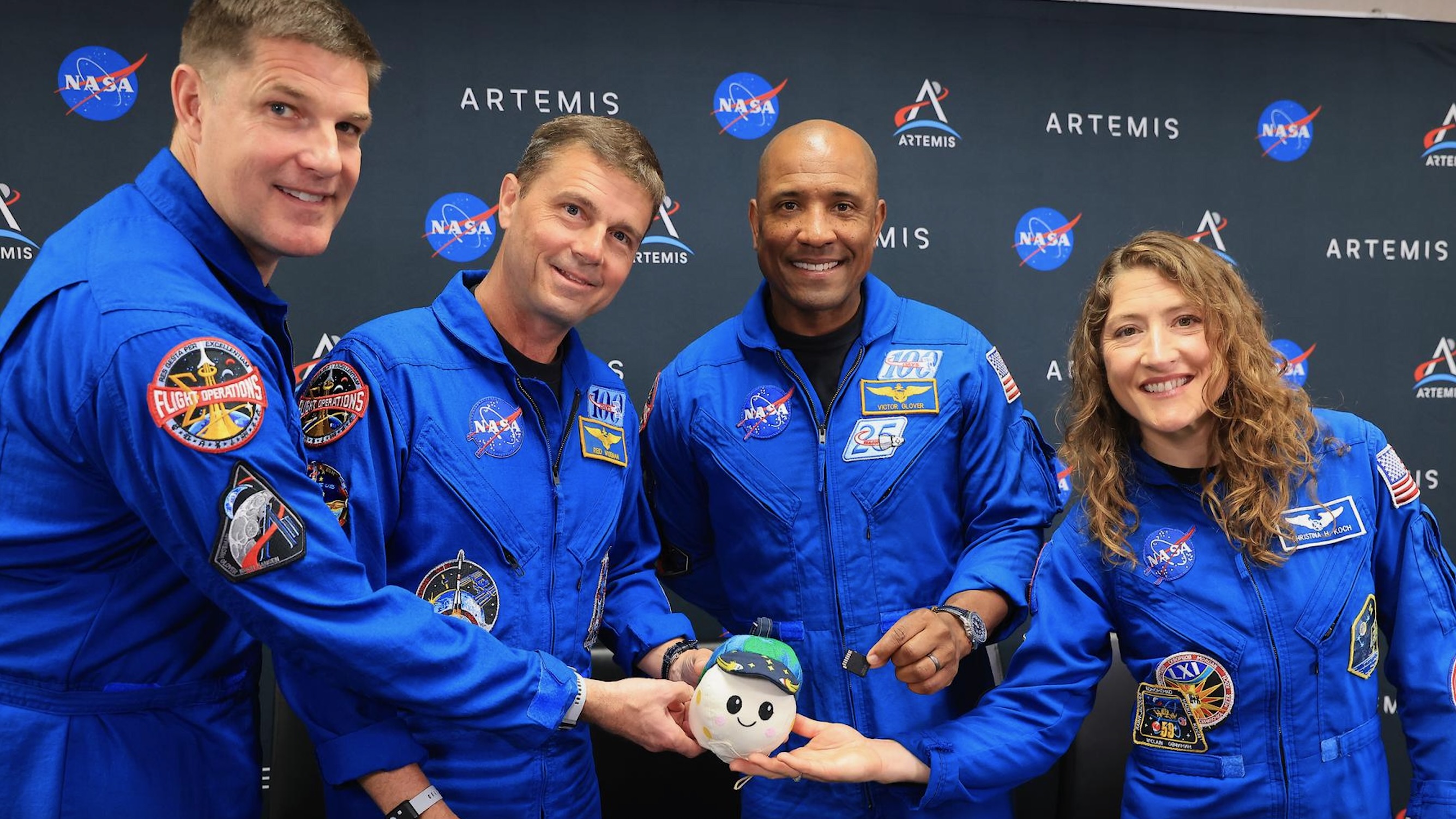 The Artemis II astronauts pose with their zero-gravity indicator, named Rise, not long before the April 1, 2026 launch of their historic moon mission.