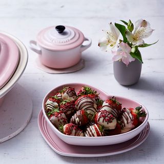heart shaped dish with desserts in shell pink and flower in vase