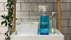 Eco-friendly cleaning products image of blue bottle of Method cleaning spray in bathroom on shelf