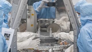 OSIRIS-REx curation team members at NASA’s Johnson Space Center begin the process of removing and flipping the TAGSAM (Touch-and-Go Sample Mechanism) from the avionics deck of the mission's science canister.