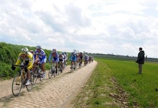 The peloton winds its way through the Paris-Roubaix course