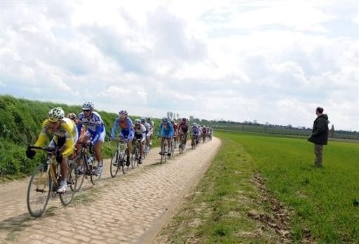 The peloton winds its way through the fields of northern France.