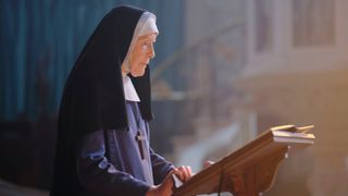Sister Monica Joan at a lectern in Call the Midwife season 12