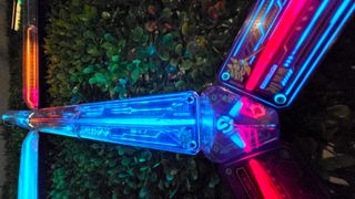 The Govee x Evangelion lighting kits set up on a wall and around a desk and drum kit with various RGB lighting modes enabled.