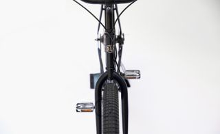 The front view of the frame of a black bicycle.