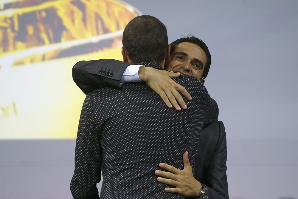 Alberto Contador hugs Ivan Basso after the Italian announced his retirement