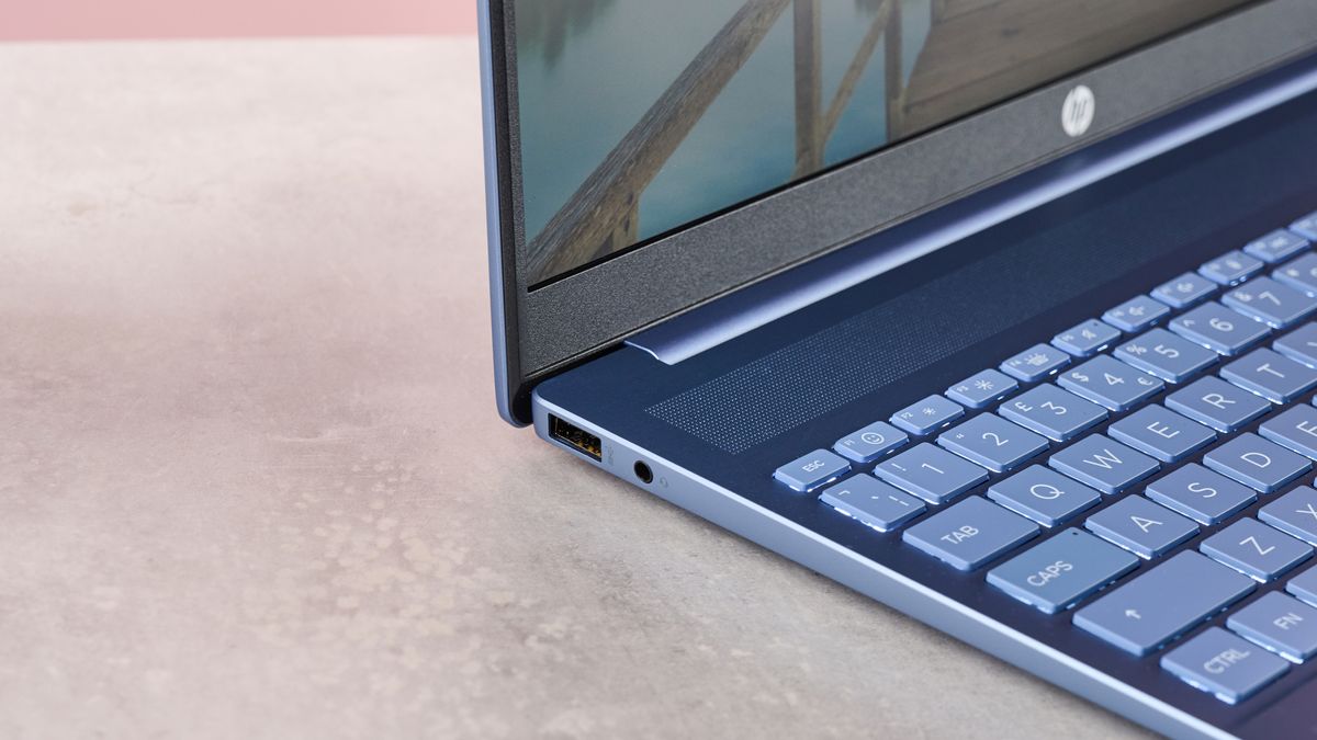 Close-up of left-side ports on HP Pavilion 16, on desk with pink wall in background