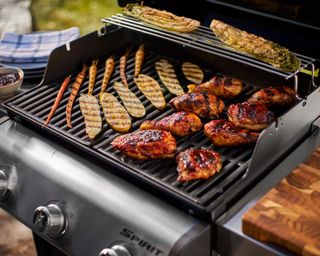 chicken being cooked on the Weber Spirit S-315 3-Burner Propane Gas Grill