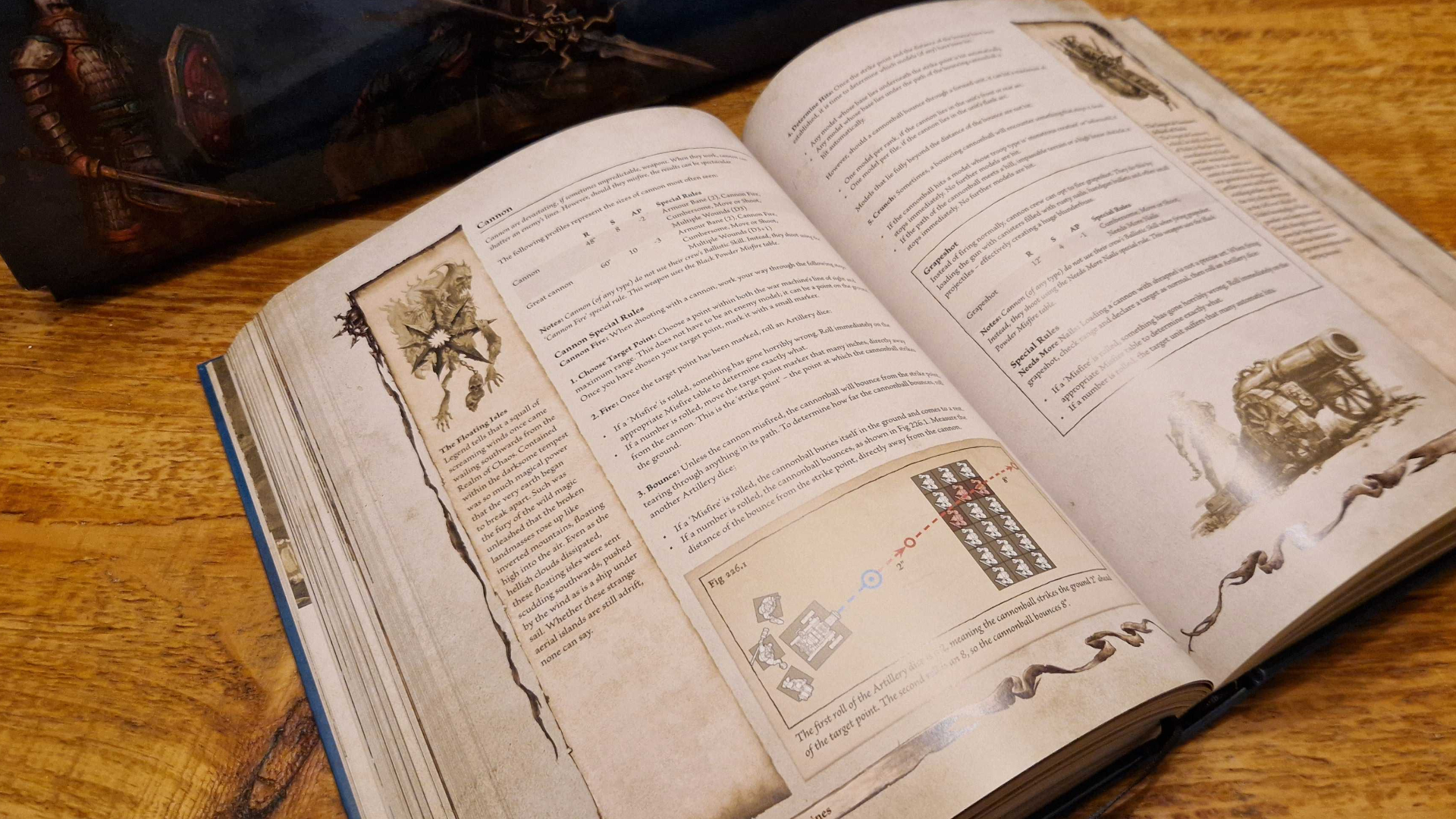 Warhammer The Old World core rulebook open on a wooden table