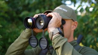 Hikmicro Habrok Pro binoculars being used by a man outdoors