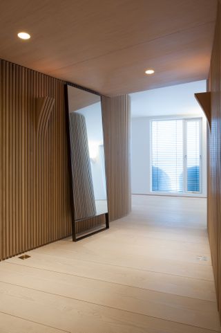 Recessed sockets and a mixture of woods, such as Douglas fir and walnut, create a seamless aesthetic across the penthouse, achieved through close collaboration between architects and craftsmen.