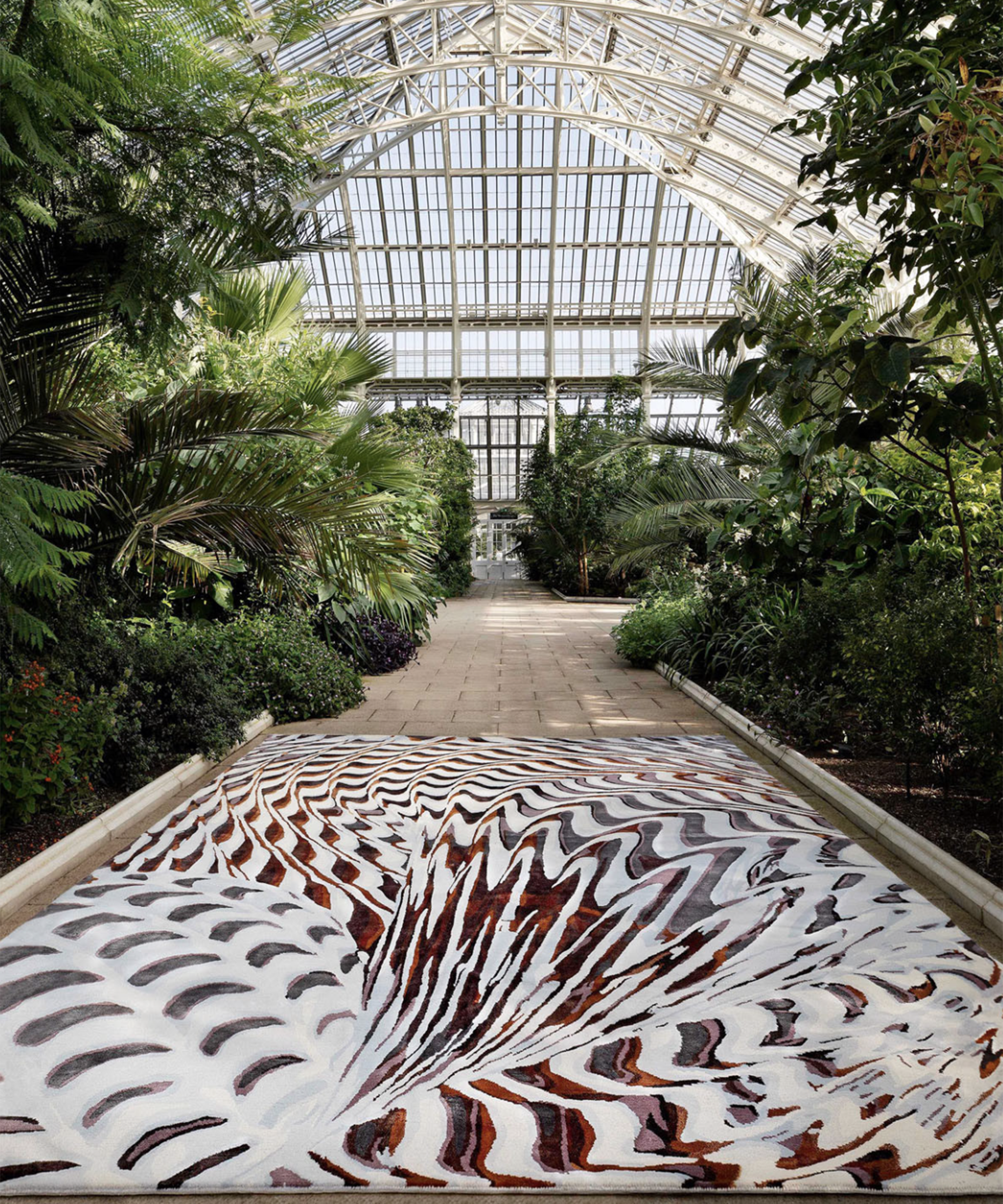 large graphic rug on the floor of a botanical green house