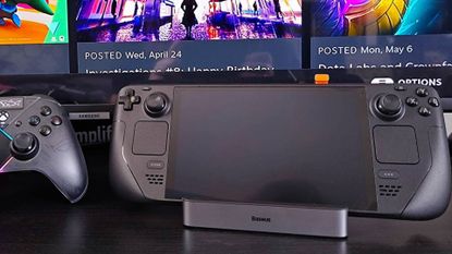 Steam Deck OLED sitting on Baseus 6-in-1 docking station with TV in backdrop and Asus controller on left.