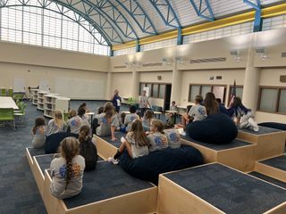 Students watching a lecture on a platform with different levels