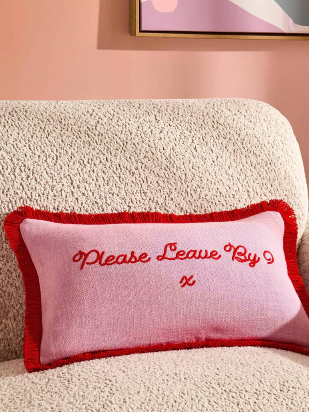 A pink and red cushion from DUSK