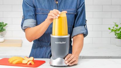 A Nutribullet 600 Series making an orange smoothie