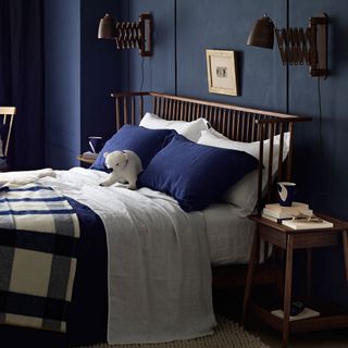 bedroom with royal blue wall and bed with soft toy