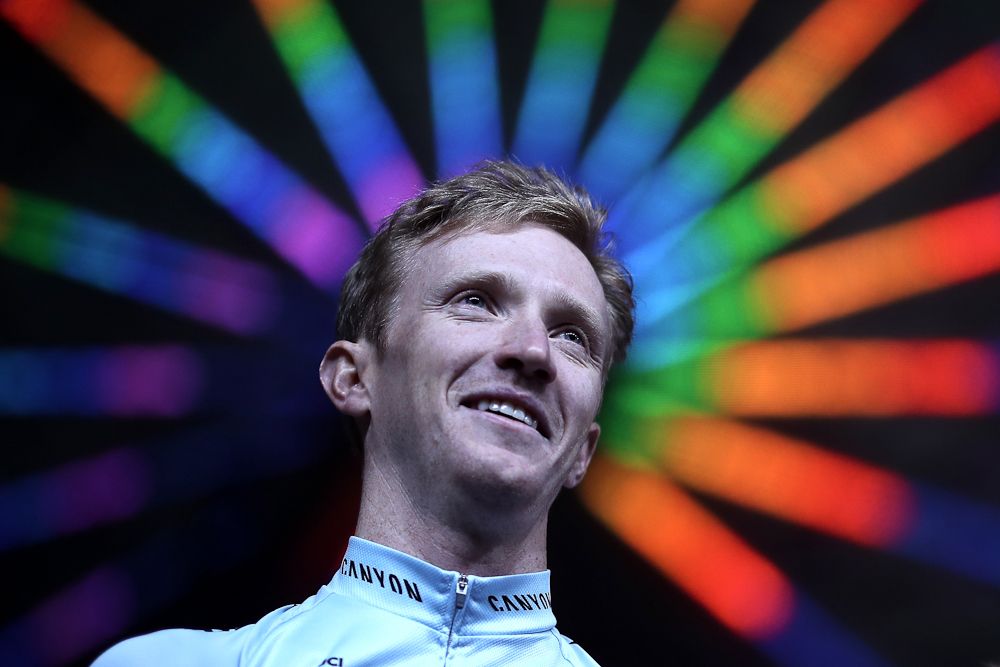 Ian Boswell stands in front of the Ferris wheel at the Tour of California team presentation