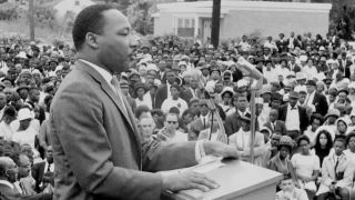 Martin Luther King Jr. speaking at an outside venue in MLK/FBI