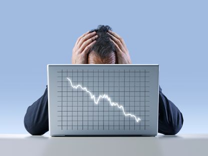 Man Holds Head In Hands As Market Crashes