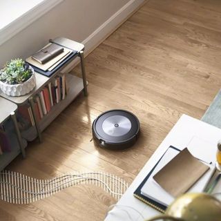 Image of iRobot roomba vacuum being used to clean house in press shot