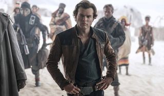 Solo: A Star Wars Story Han stands arms akimbo, listening to the plan