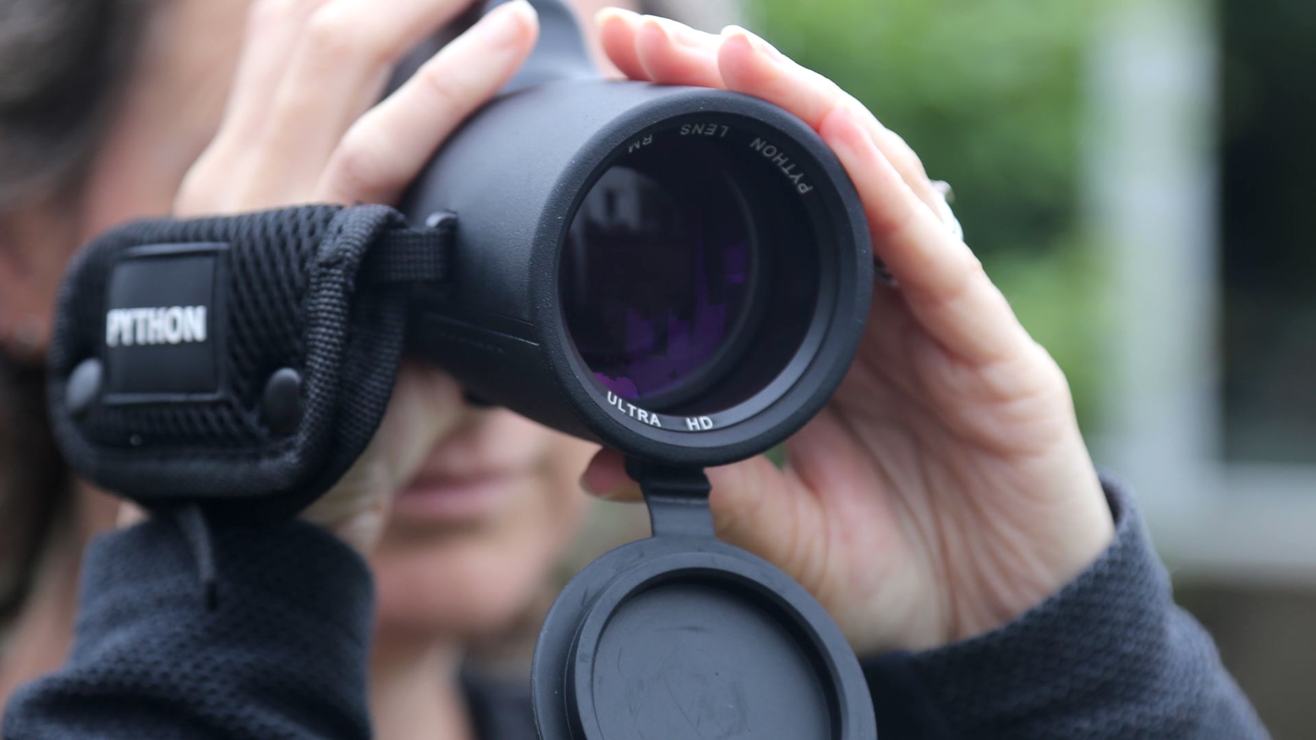 Someone looking through a monocular.