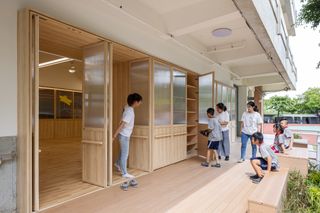 Comfortable hallway for children to sit and change shoes or take a break safely at Tainan Sinhua Elementary School