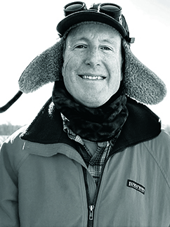 Artist headshot; a man in a hat