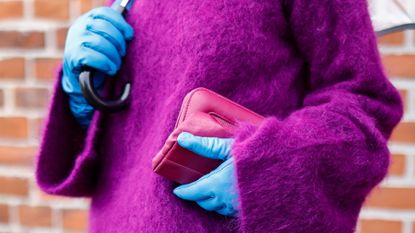 COPENHAGEN, DENMARK - FEBRUARY 01: Influencer Grece Ghanem wearing a purple turtleneck pullover by Gestuz, light blue leather gloves by Gestuz, a pink clutch by Gestuz, is seen at the GESTUZ fashion show on February 1, 2022 in Copenhagen, Denmark. (Photo by Streetstyleshooters/Getty Images)