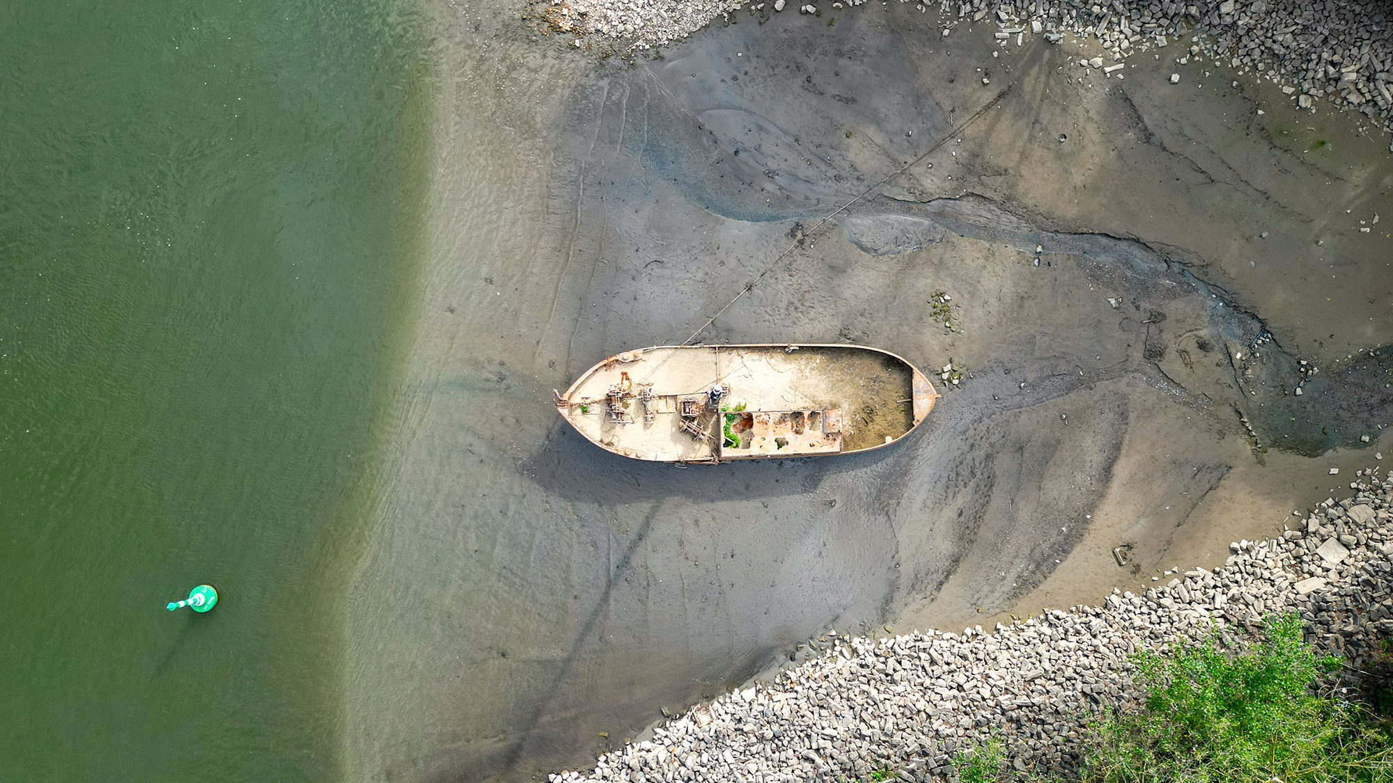 The shipwreck of a fishing boat emerges amid historically low water levels on the Rhine River near Neuss, Germany