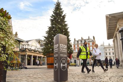 christmas tree in Covent Garden, London, just days before the tiers are announced for England