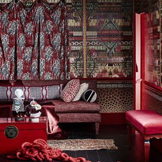 living room with wooden flooring and red sofa set