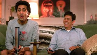 Kal Penn and John Cho on a couch in Harold and Kumar Go to White Castle