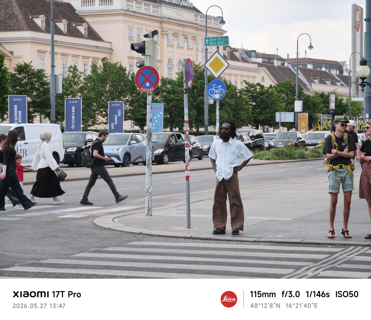 A man waits at a crosswalk in Vienna
