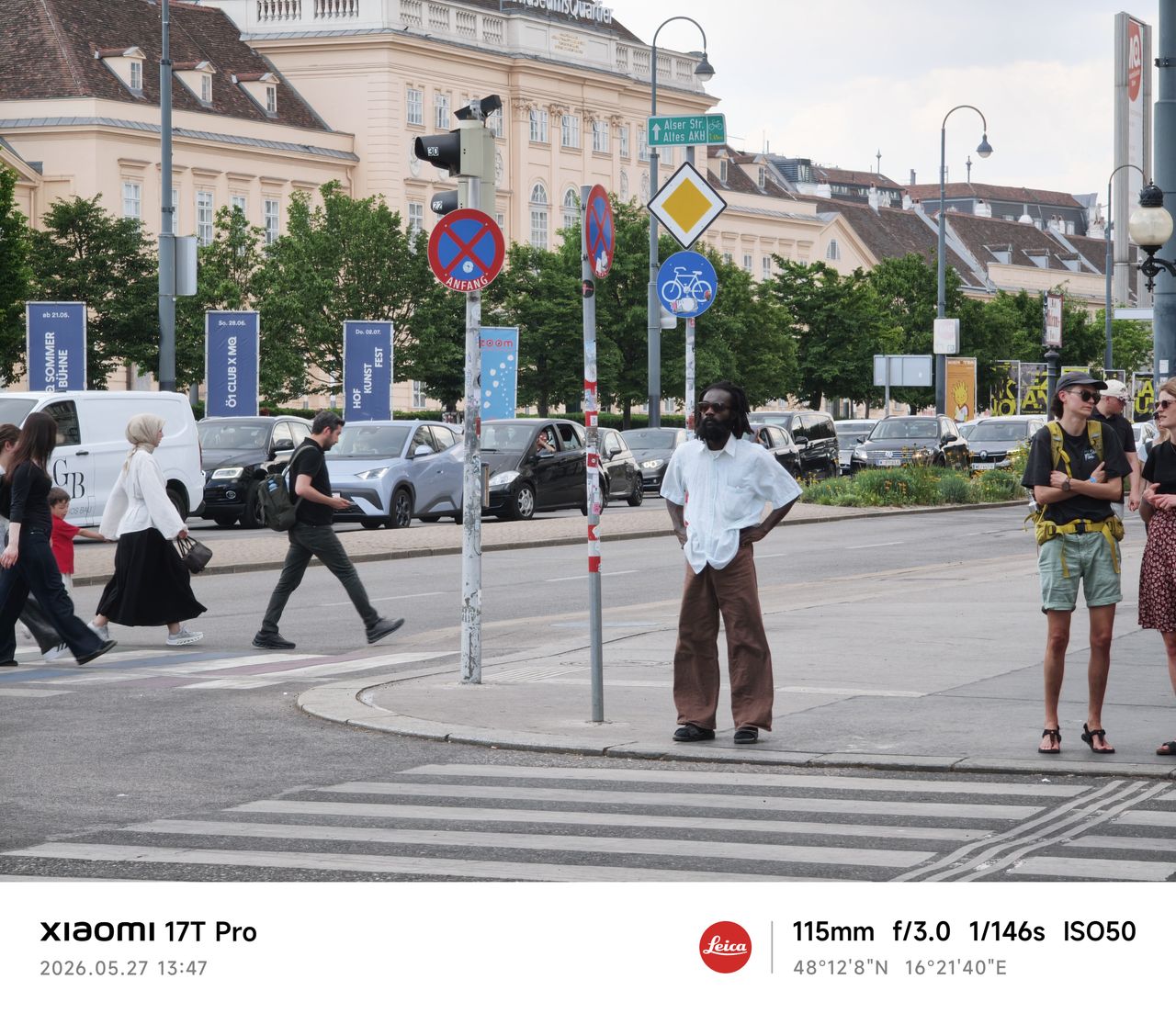 A man waits at a crosswalk in Vienna