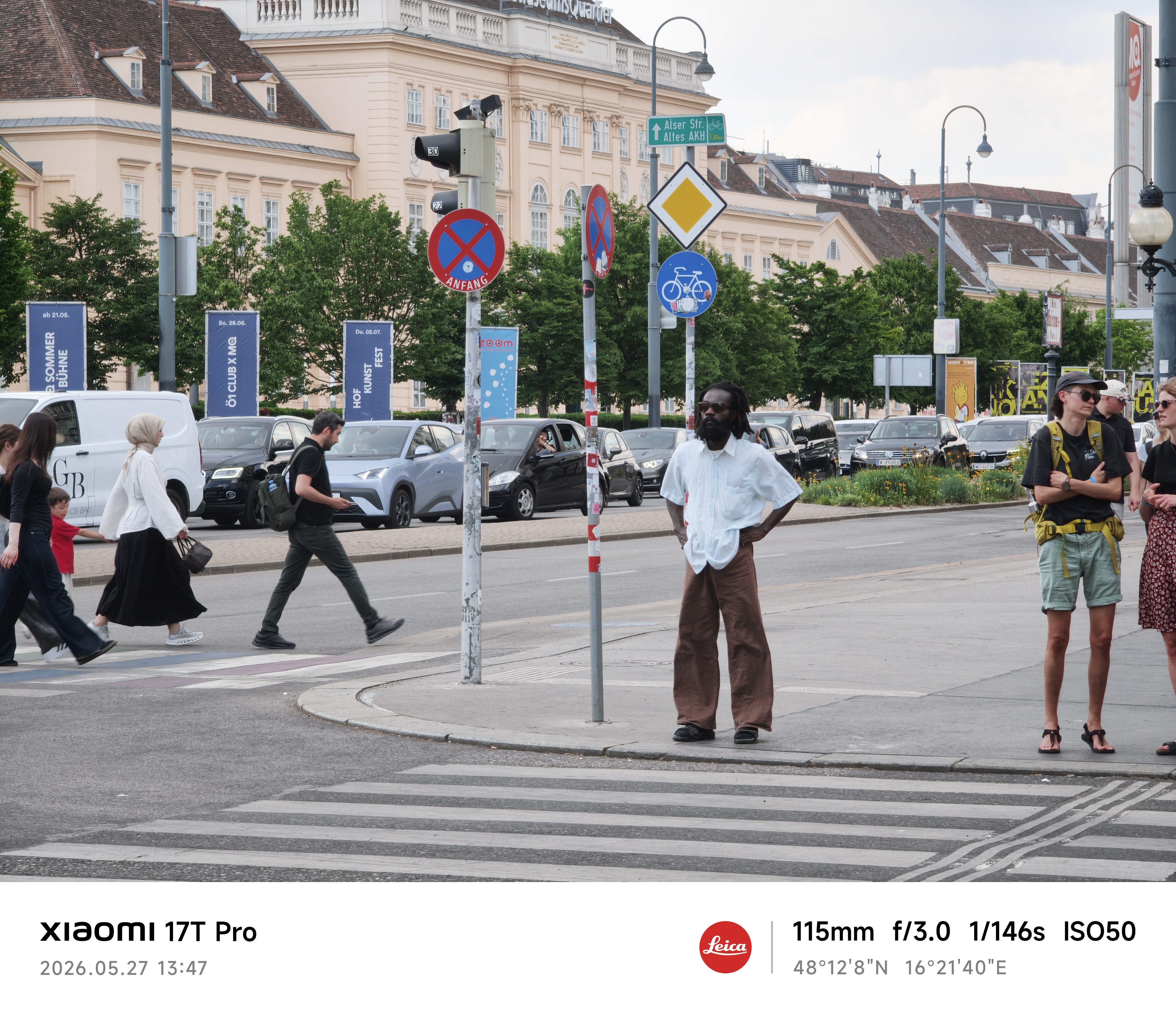 A man waits at a crosswalk in Vienna