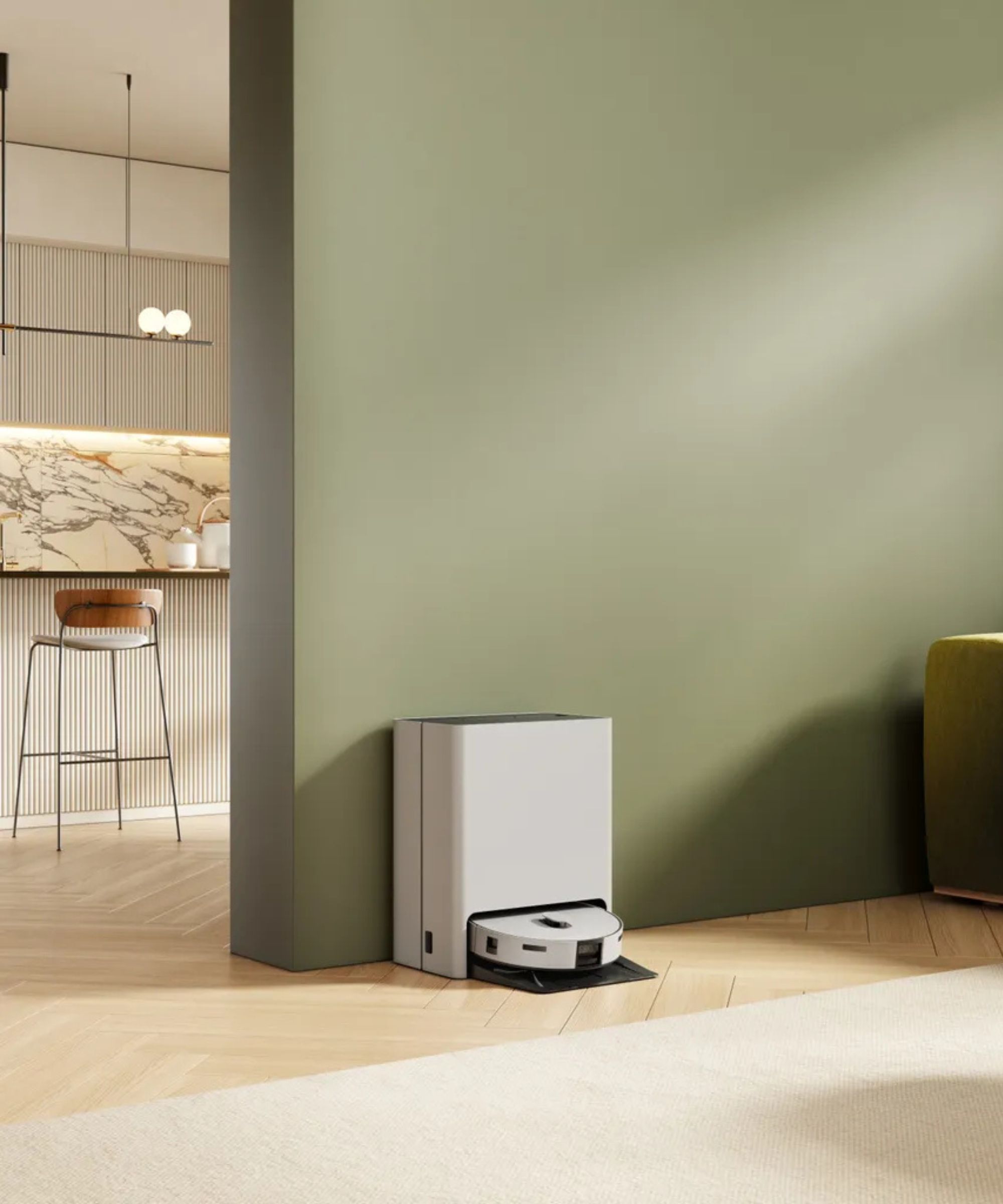 Samsung AI Jet Bot Combo against green wall with kitchen stool in background, on wooden floors.