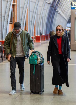 Sophie Turner and her boyfriend at the airport while she wears Uggs