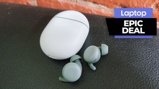 Google Pixel Buds A-Series wireless earbuds in green colorway against a brick wall background