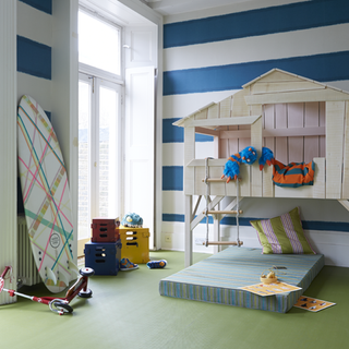 kids room with white wooden beach hut and mattress with pillow