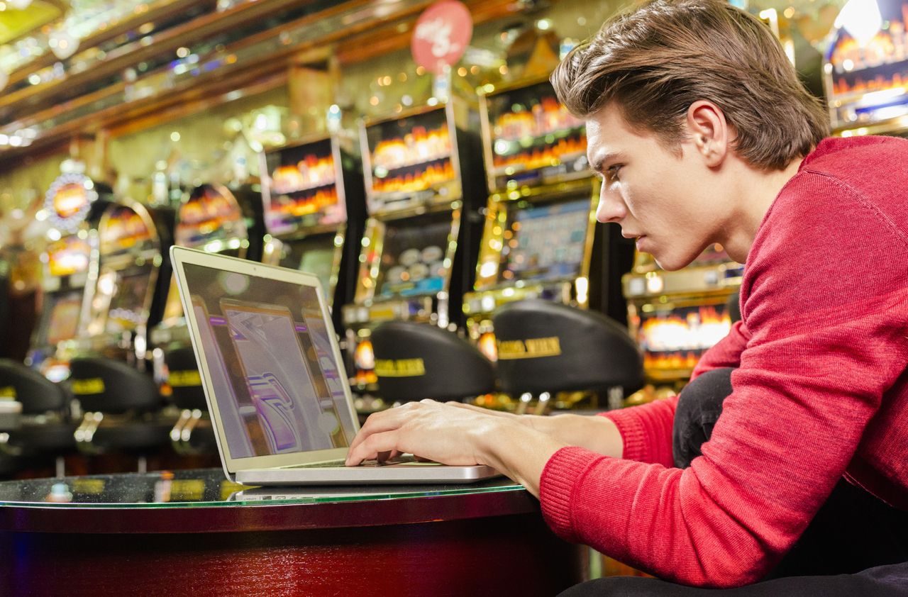 Young man playing online games with his laptop