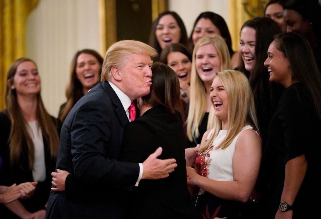  President Donald Trump hugs a member of the Oklahoma women&amp;#039;s softball team in the East Room of the White House during an event with NCAA national championship teams on November 17, 2017