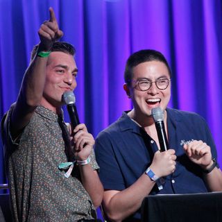 matt rogers and bowen hang hold microphones on stage at an event for Las Culturistas