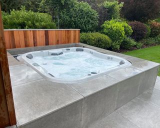 built in hot tub on a patio in a garden